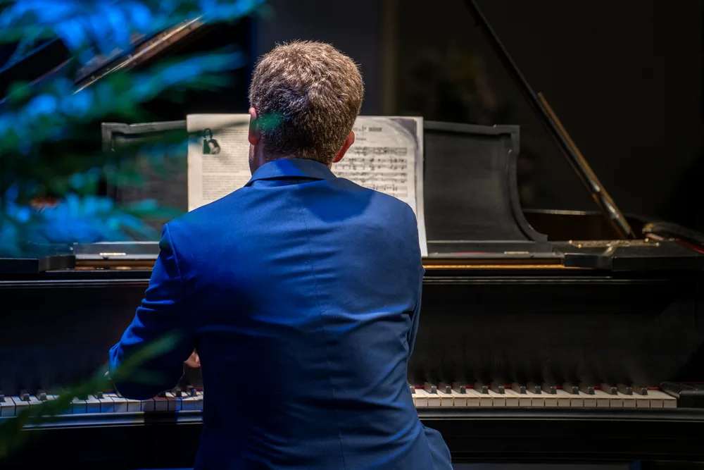 A pianist on a dark stage, 2024