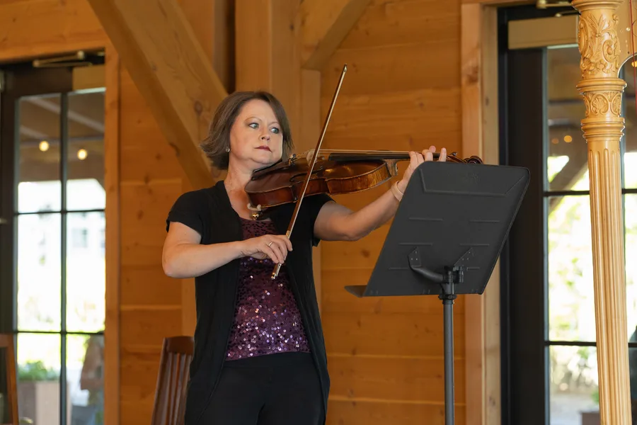 A violinist performing at the Lake House